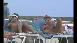 Nude Beach Spycam — Biker chick spreading for hidden camera on the beach